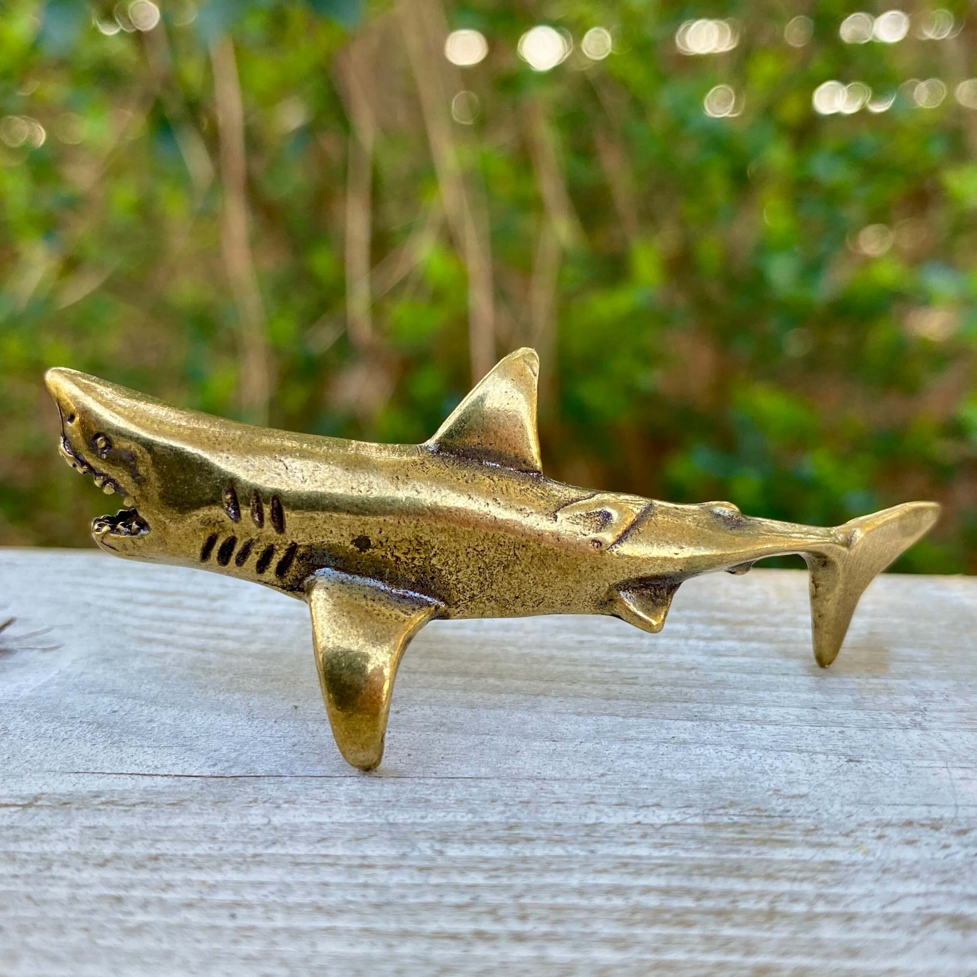 Solid brass shark sculpture by Wild Brass, symbol of power, agility, and strength, featuring detailed shark design.