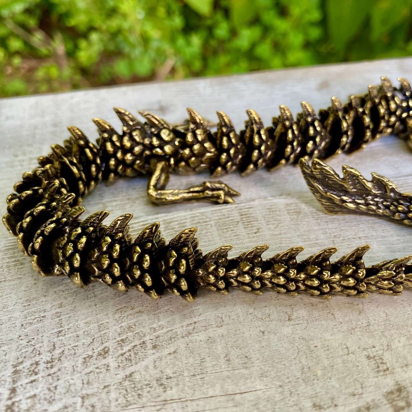 Solid brass large bendable dragon sculpture by Wild Brass, symbolizing power, wisdom, and transformation, with detailed craftsmanship.