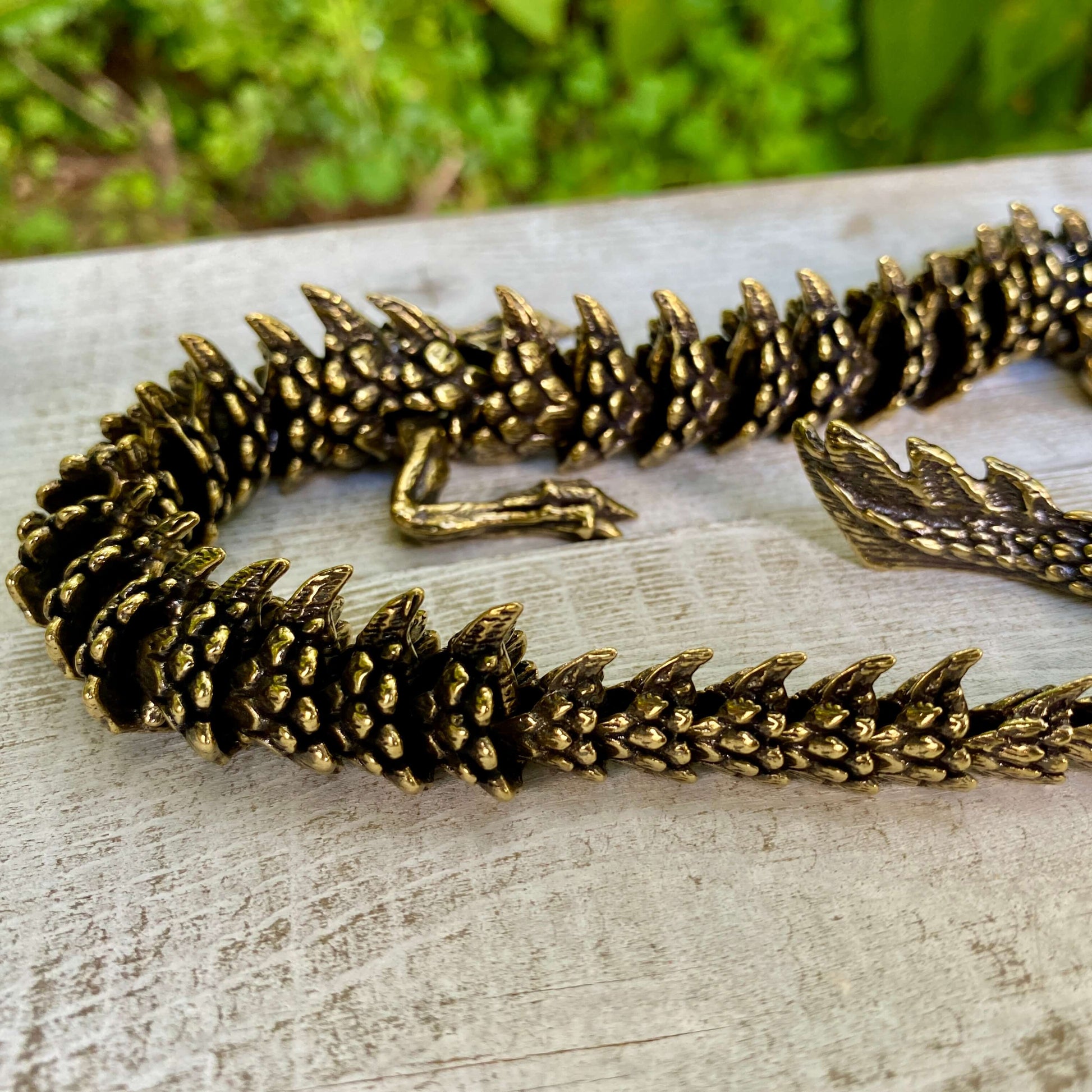 Solid brass large bendable dragon sculpture by Wild Brass, symbolizing power, wisdom, and transformation, with detailed craftsmanship.