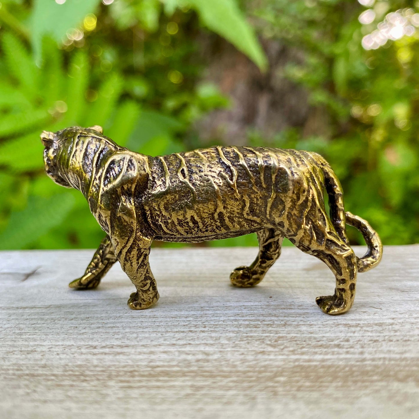 Solid brass tiger sculpture by Wild Brass, symbol of power, passion, and independence, featuring detailed craftsmanship.