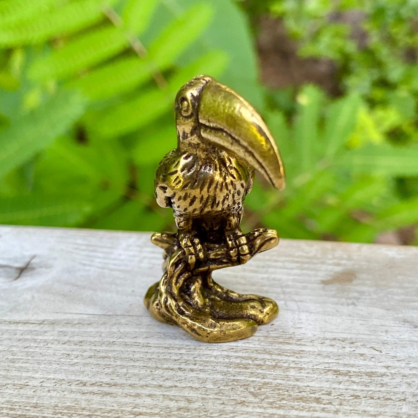 Solid brass toucan bird sculpture by Wild Brass, showcasing vibrant colors and playful design symbolizing communication and vibrancy.