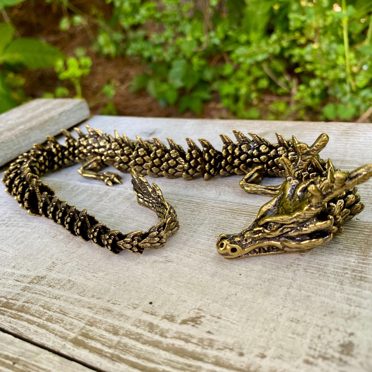 Solid brass large bendable dragon figurine by Wild Brass, featuring detailed scales and a dynamic pose symbolizing power and wisdom.