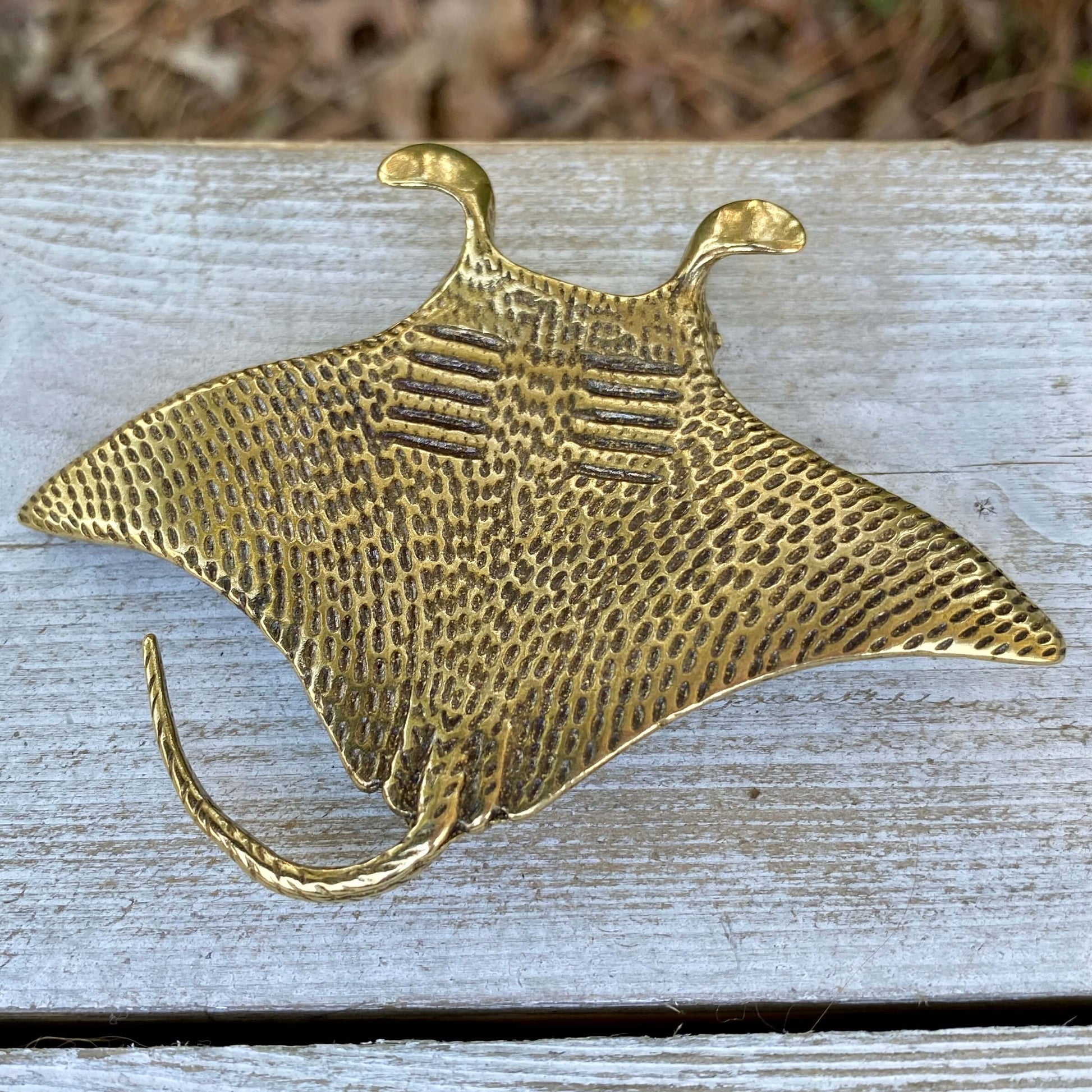 Solid brass manta ray sculpture by Wild Brass, symbol of grace and freedom, featuring detailed fins and sleek body.