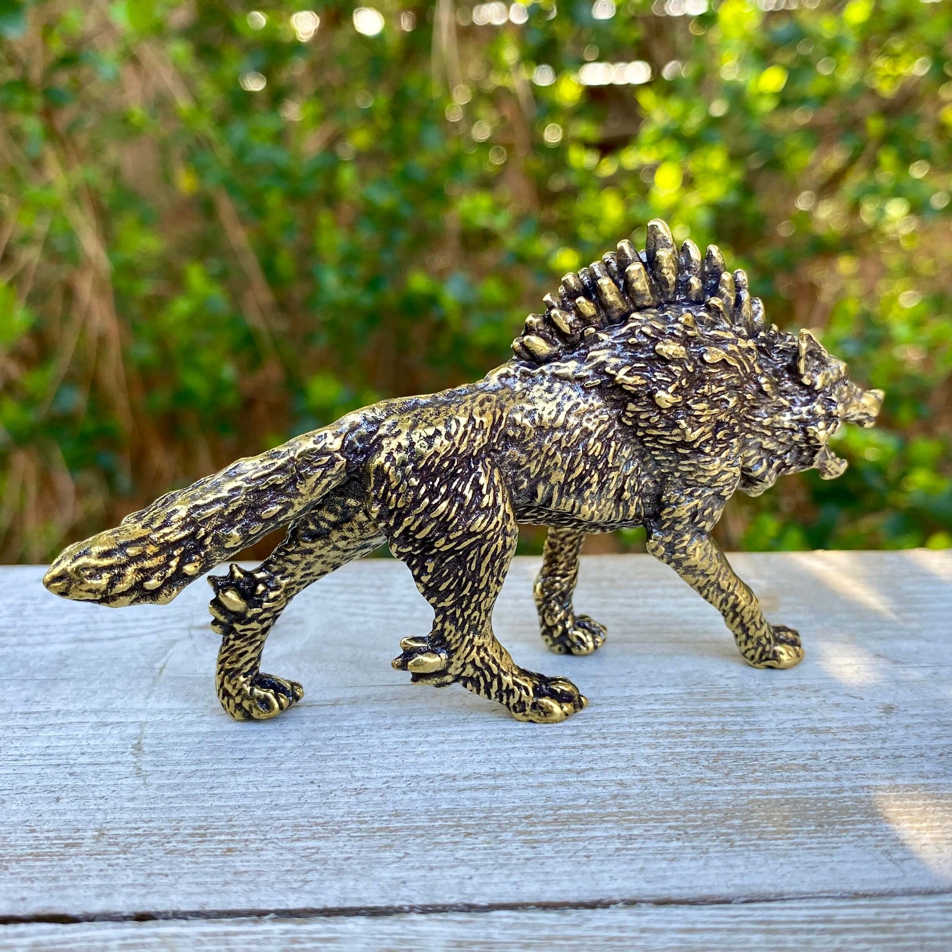 Solid brass Wolverine figurine by Wild Brass, symbolizing independence, survival, and untamed spirit, detailed craftsmanship visible.