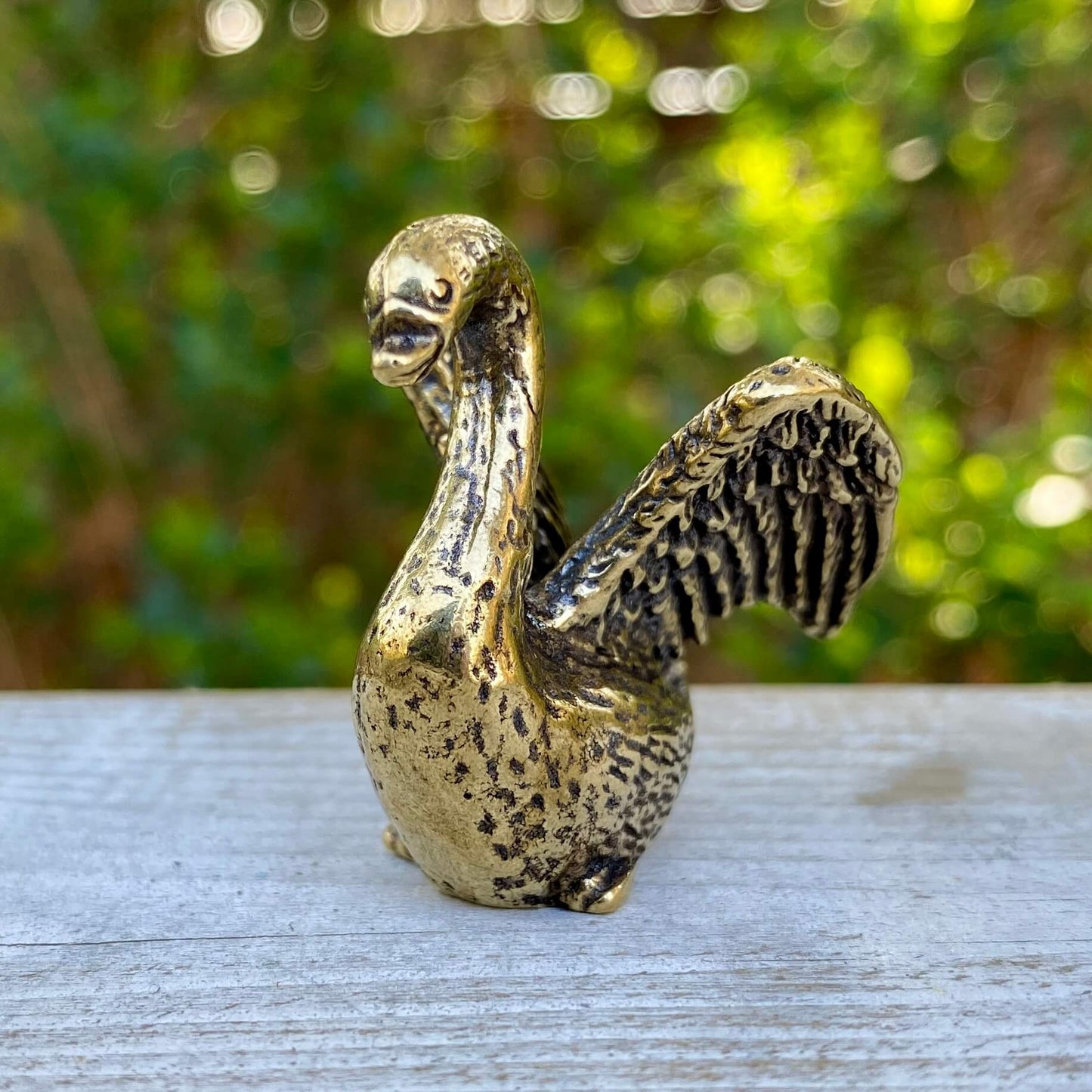Solid brass swan figurine by Wild Brass, symbol of beauty, grace, and elegance, with detailed curved neck and smooth finish.