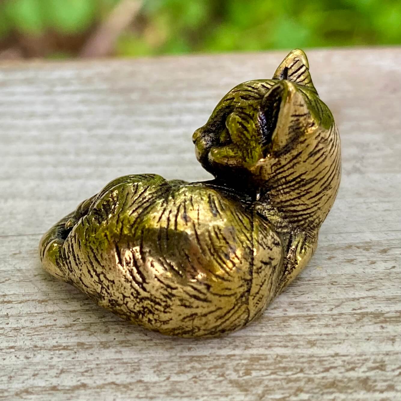 Solid brass cat sculpture by Wild Brass, showcasing a graceful feline figure symbolizing independence and mystery.