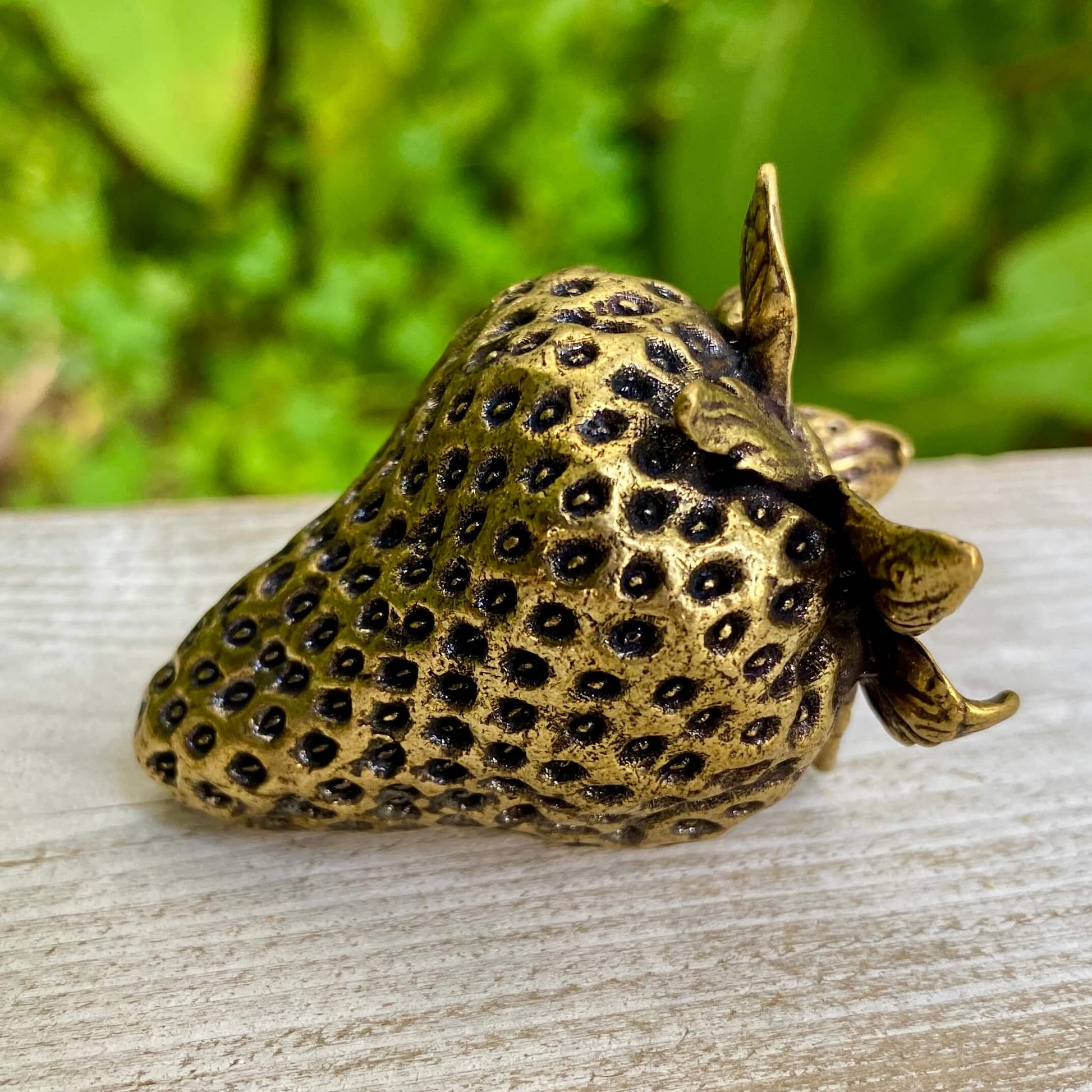Solid brass strawberry figurine by Wild Brass, symbol of love, passion, and abundance, with detailed craftsmanship.