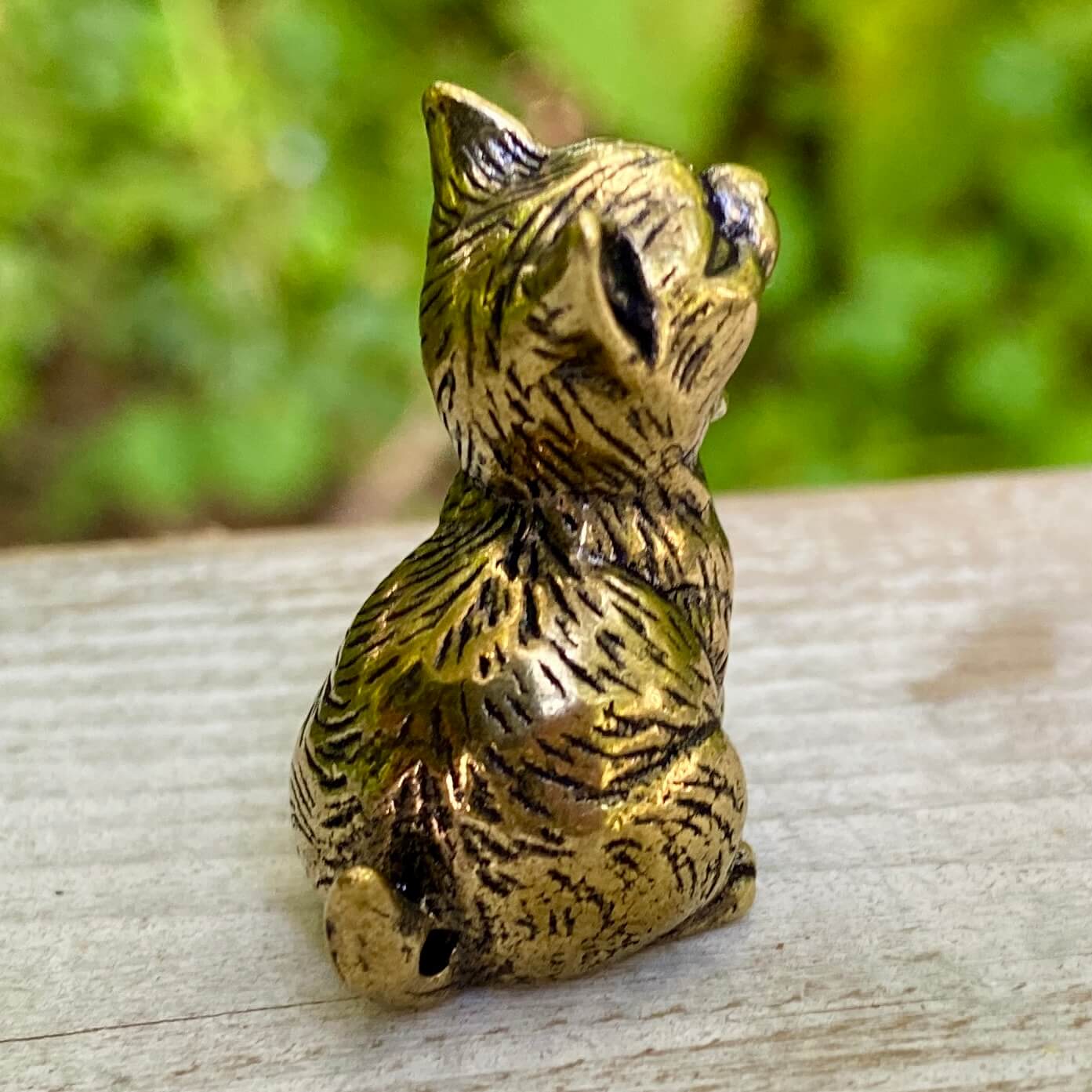 Solid brass cat figurine by Wild Brass, symbol of independence, mystery, and intuition, shown with detailed craftsmanship.