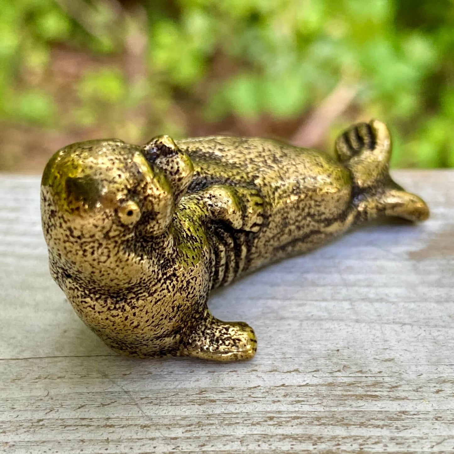 Solid brass walrus figurine by Wild Brass, symbol of wisdom, strength, and community, with detailed craftsmanship in a natural pose.