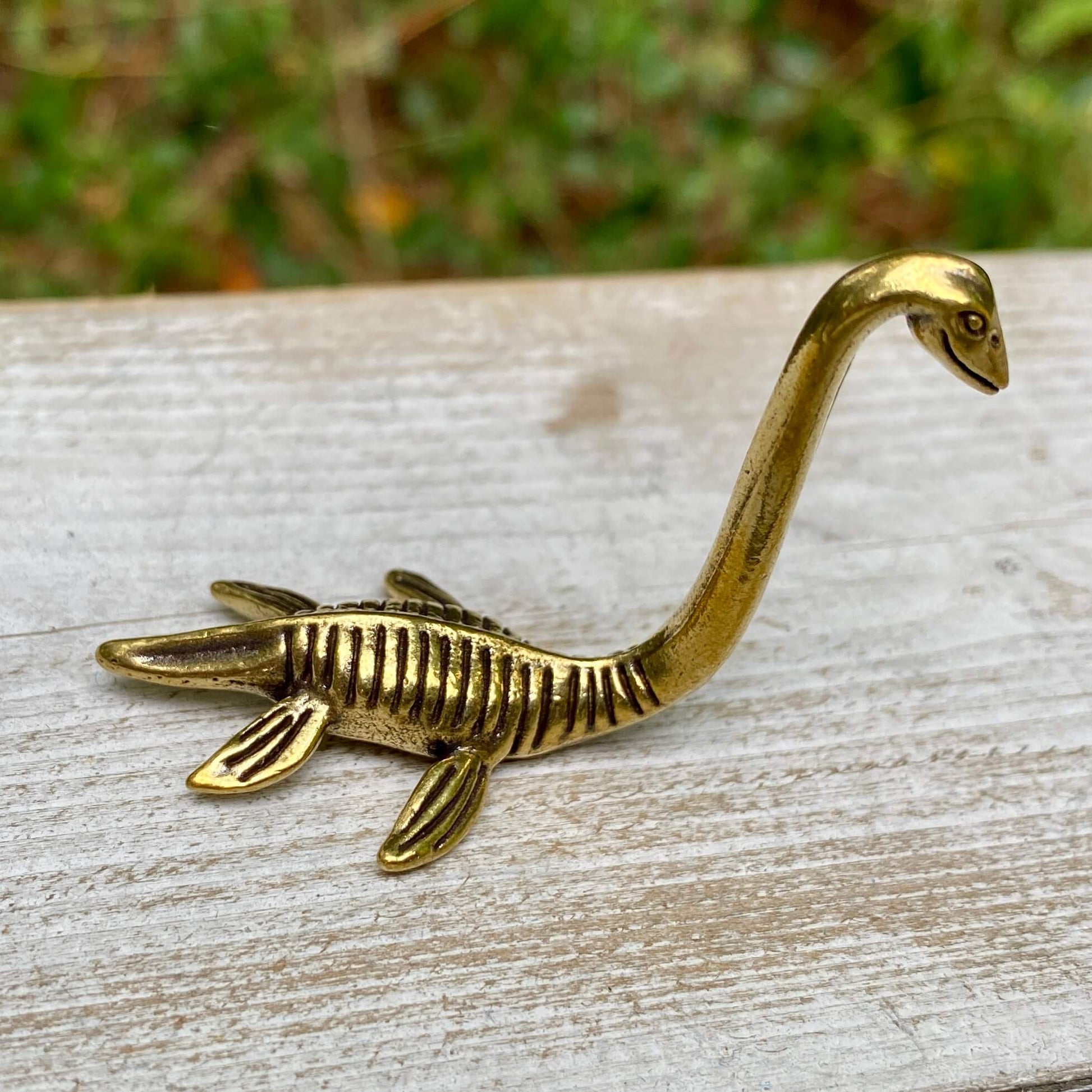 Solid brass Loch Ness Monster figurine by Wild Brass, featuring a mythical creature symbolizing mystery and magic.