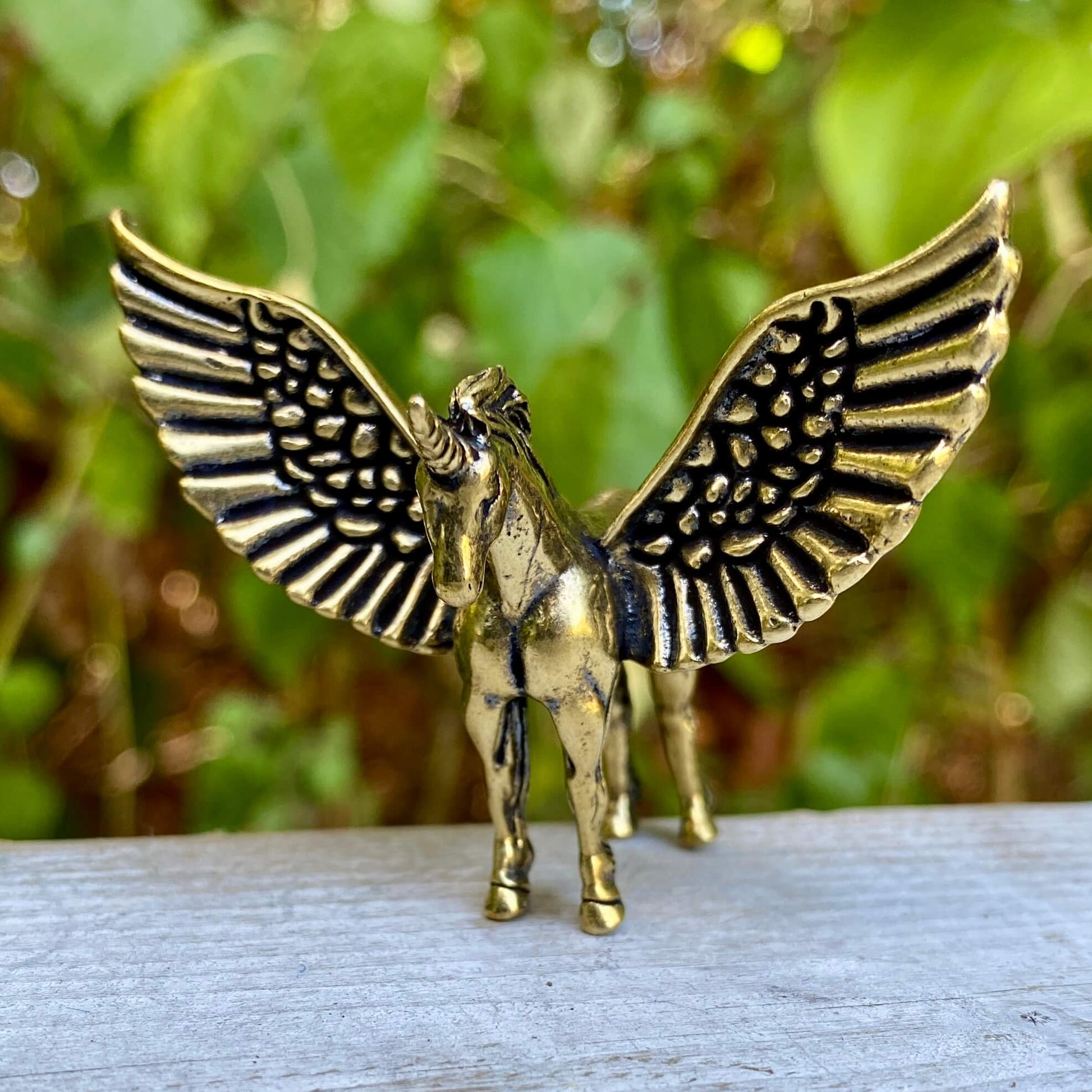 Solid brass Pegasus figurine by Wild Brass, symbol of freedom, inspiration, and divine power, shown on a neutral background.