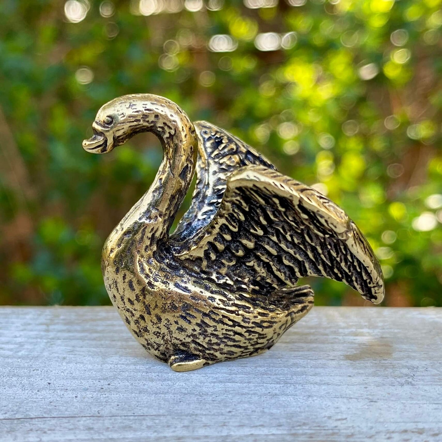 Solid brass swan figurine by Wild Brass, showcasing a graceful and elegant bird sculpture with a shiny, polished finish.