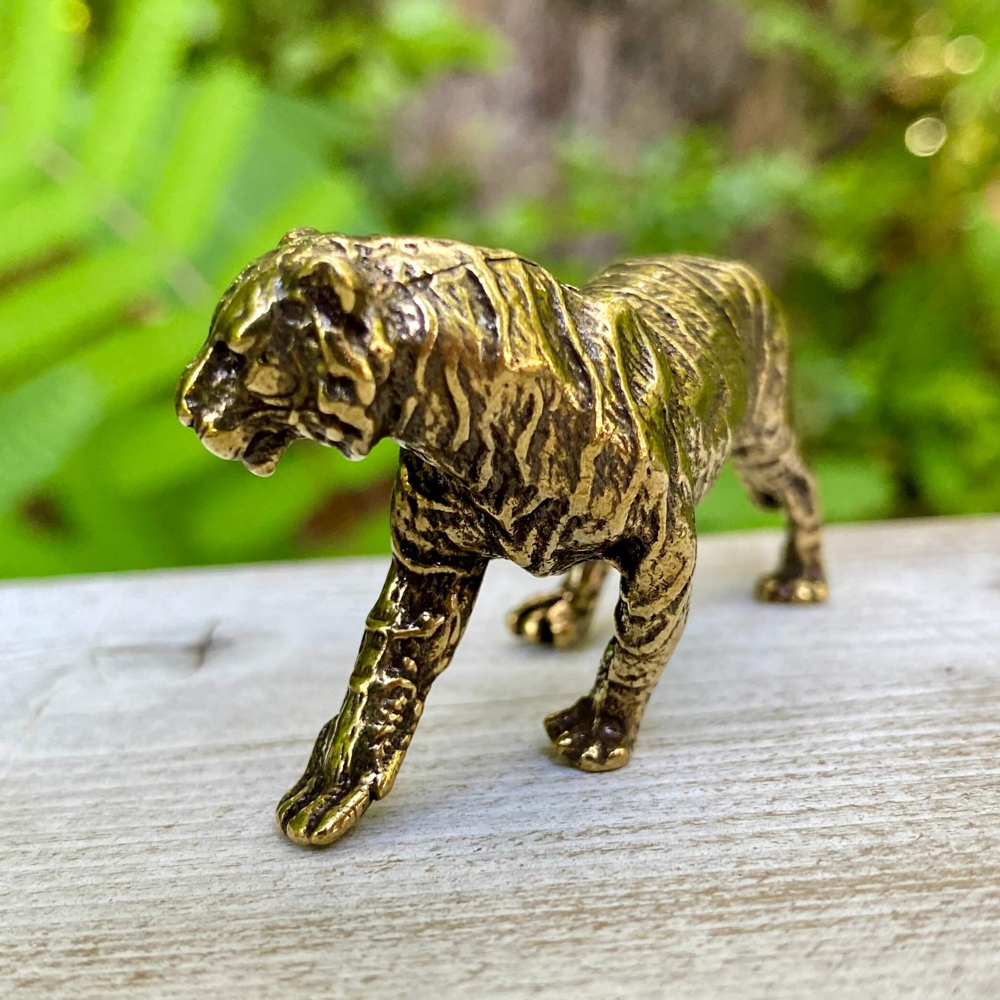 Solid brass tiger sculpture by Wild Brass, symbolizing power, passion, and independence, with detailed craftsmanship and a polished finish.