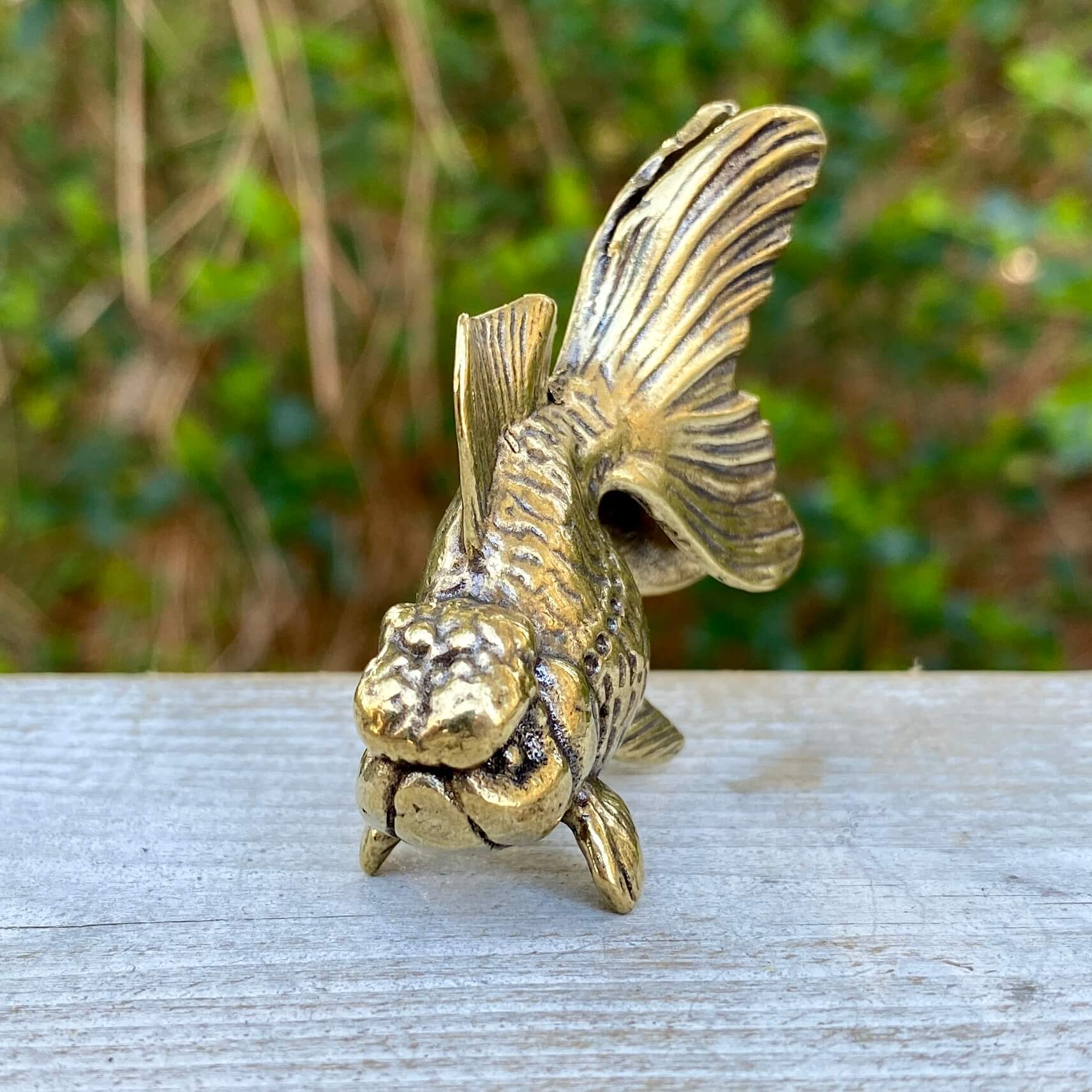Solid brass goldfish sculpture by Wild Brass, showcasing detailed craftsmanship symbolizing beauty, tranquility, and abundance.
