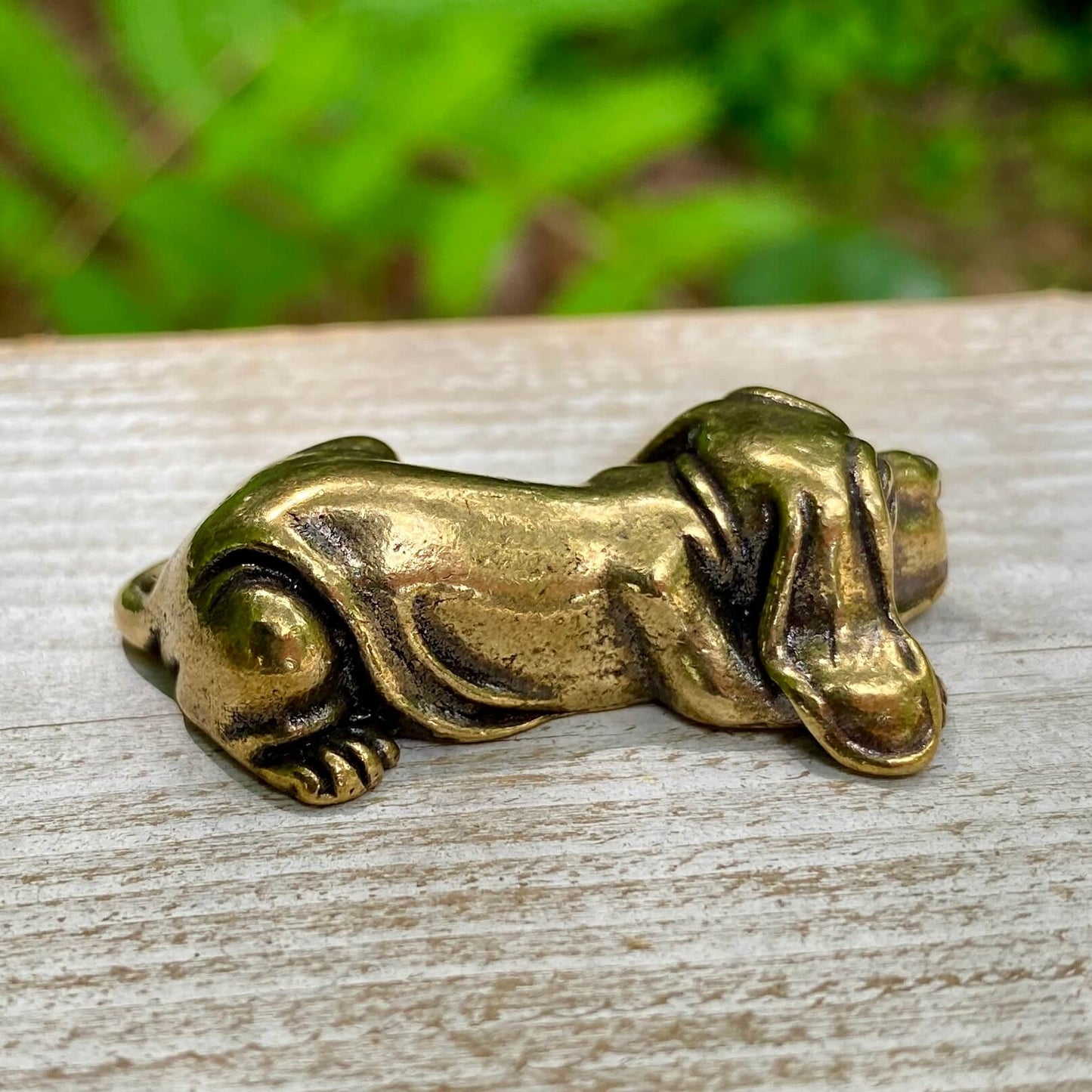 Solid brass Basset Hound sculpture by Wild Brass, showcasing a detailed, calm dog figure symbolizing loyalty and persistence.