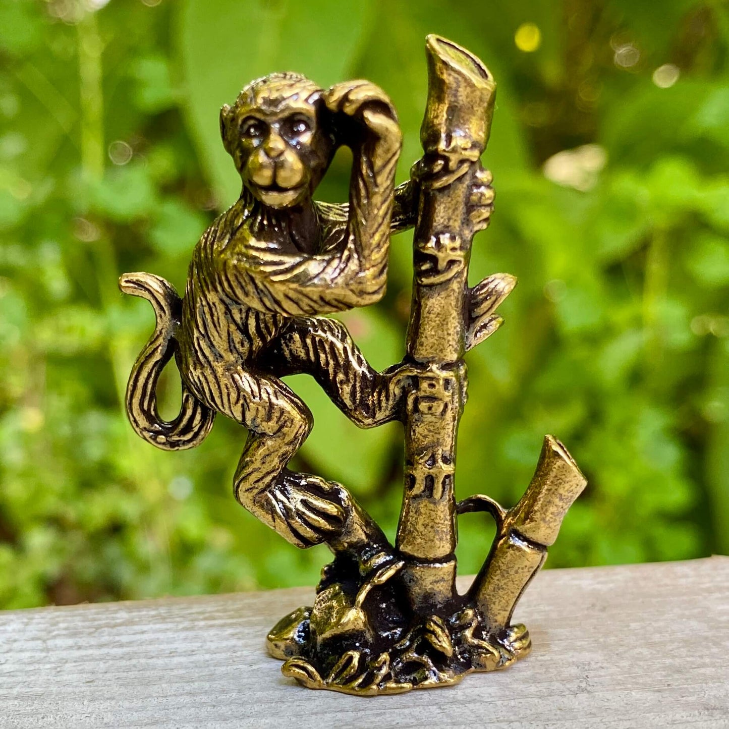 Solid brass monkey sculpture on bamboo base by Wild Brass, symbolizing balance, joy, and harmony in decorative art.