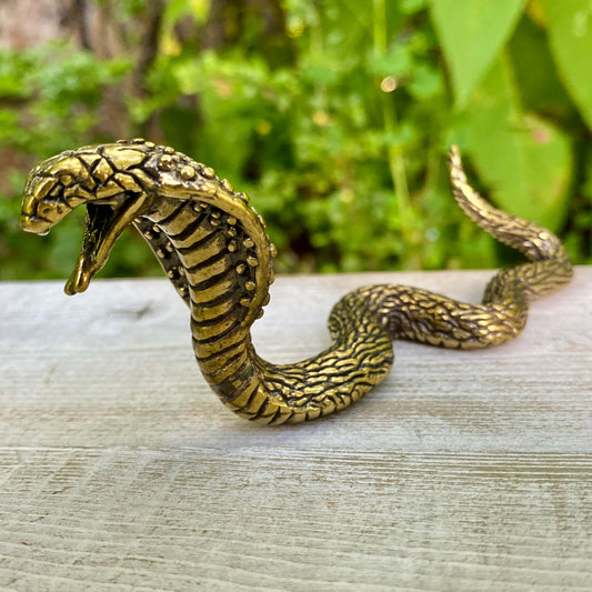 Solid brass cobra snake sculpture by Wild Brass, symbol of transformation, power, and protection, detailed and polished finish.
