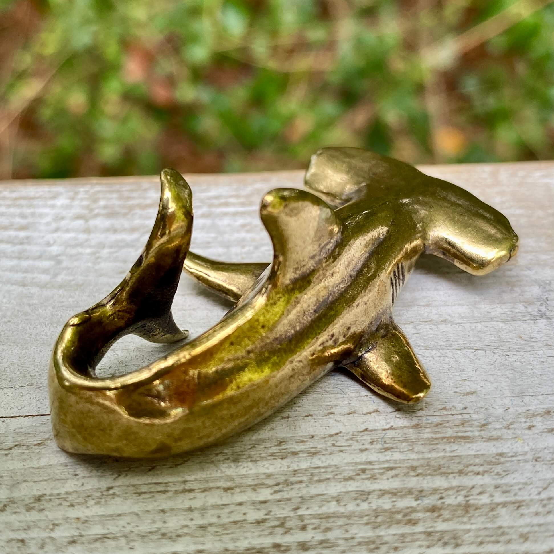 Solid brass hammerhead shark sculpture by Wild Brass, symbolizing perception, adaptability, and strength, with detailed features.