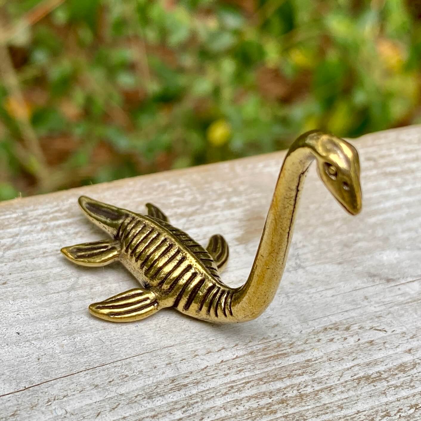 Solid brass Loch Ness Monster sculpture by Wild Brass, featuring mystical creature with intricate detailing and a mysterious presence.