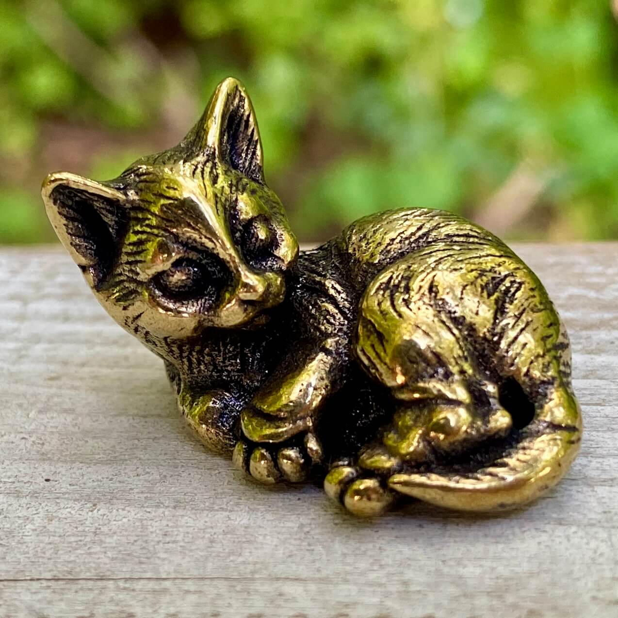 Solid brass cat sculpture by Wild Brass, showcasing a sleek feline figure symbolizing independence, grace, and mystery.