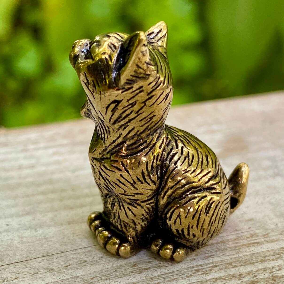 Solid brass cat sculpture by Wild Brass, symbol of independence, mystery, and intuition, shown with detailed feline features.