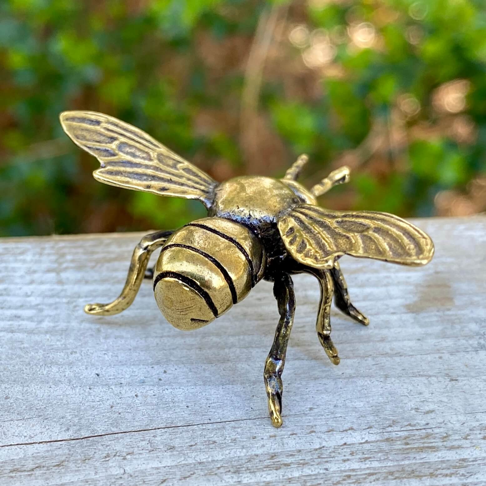 Solid brass bee symbol by Wild Brass, showcasing detailed craftsmanship representing harmony, beauty, and purpose.