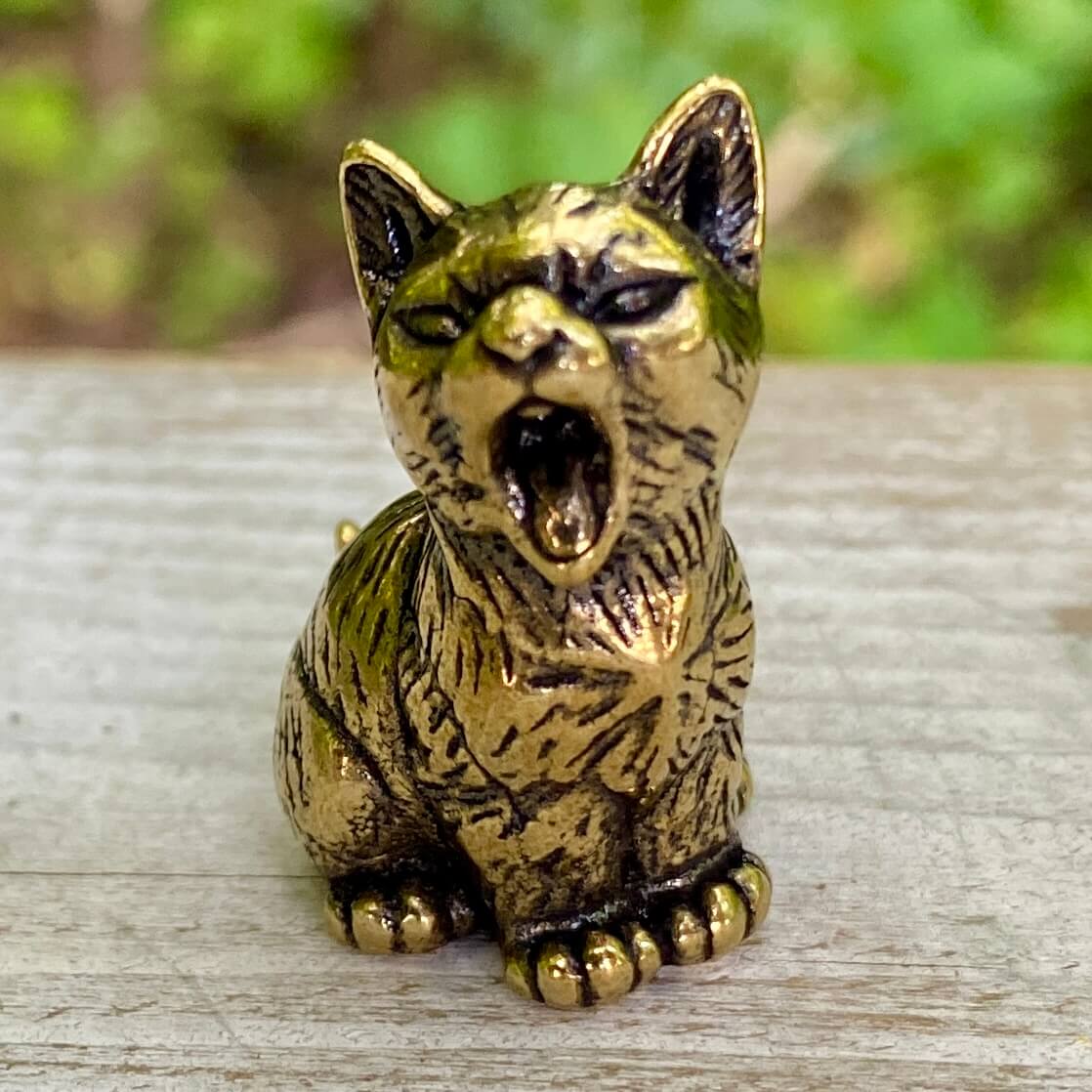 Solid brass cat sculpture by Wild Brass, showcasing a sleek feline figure symbolizing independence, mystery, and intuition.