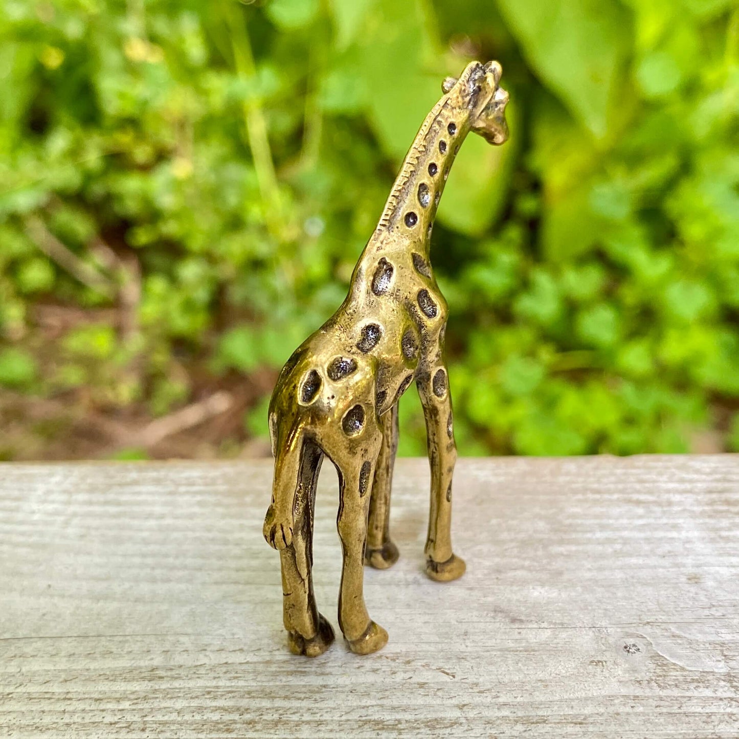 Solid brass giraffe sculpture by Wild Brass, symbol of intuition and power, shown in a detailed close-up.