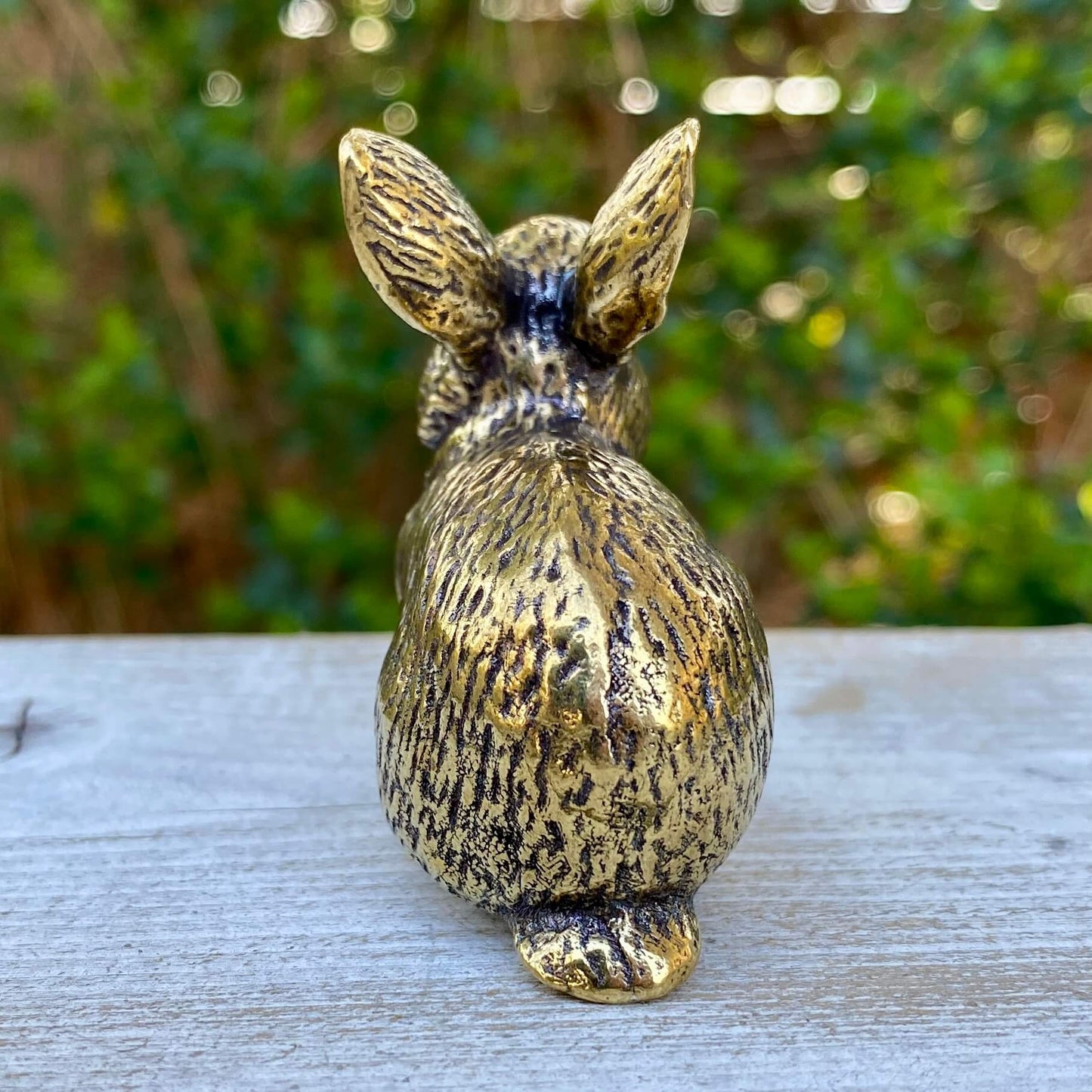Solid brass rabbit sculpture by Wild Brass, symbolizing gentleness, abundance, and good fortune, shown in a detailed close-up.