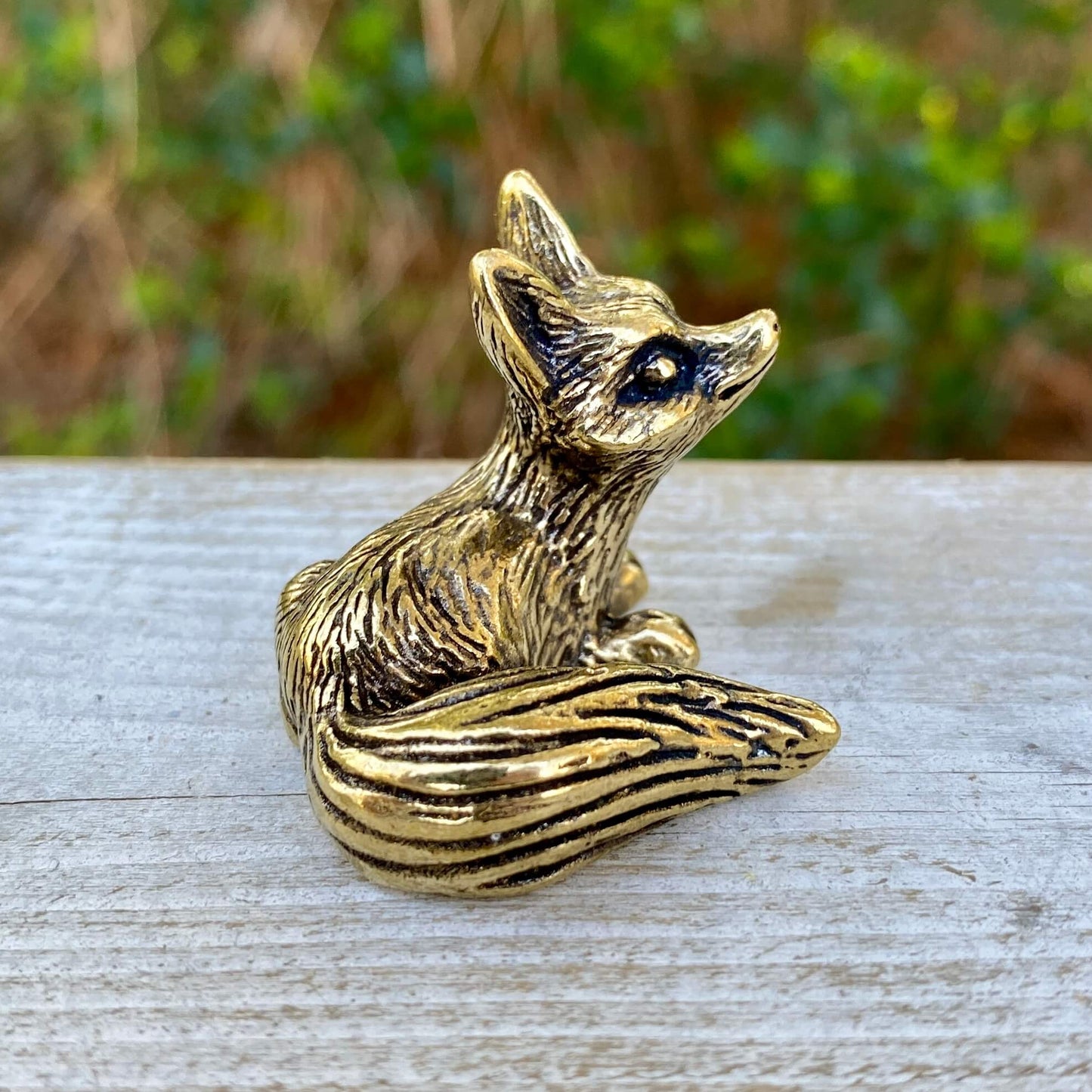 Solid brass fox figurine sitting symbolizing cleverness and adaptability, crafted by Wild Brass.