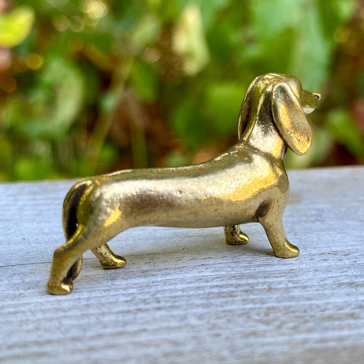 Solid brass dachshund dog figurine by Wild Brass, symbol of courage, loyalty, and tenacity, with detailed craftsmanship.