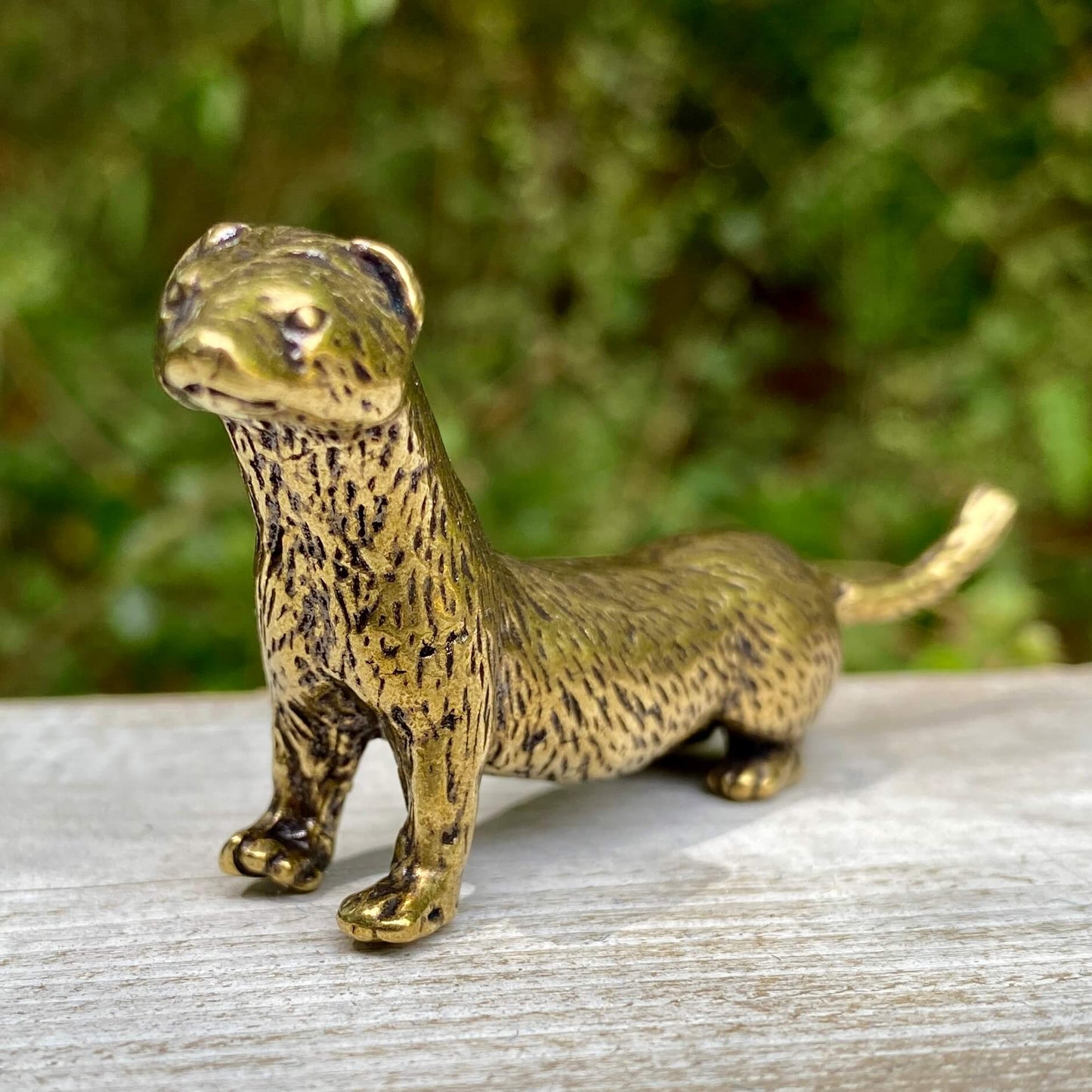 Solid brass weasel figurine by Wild Brass, symbol of cunning, agility, and resourcefulness, detailed metal sculpture on neutral background.