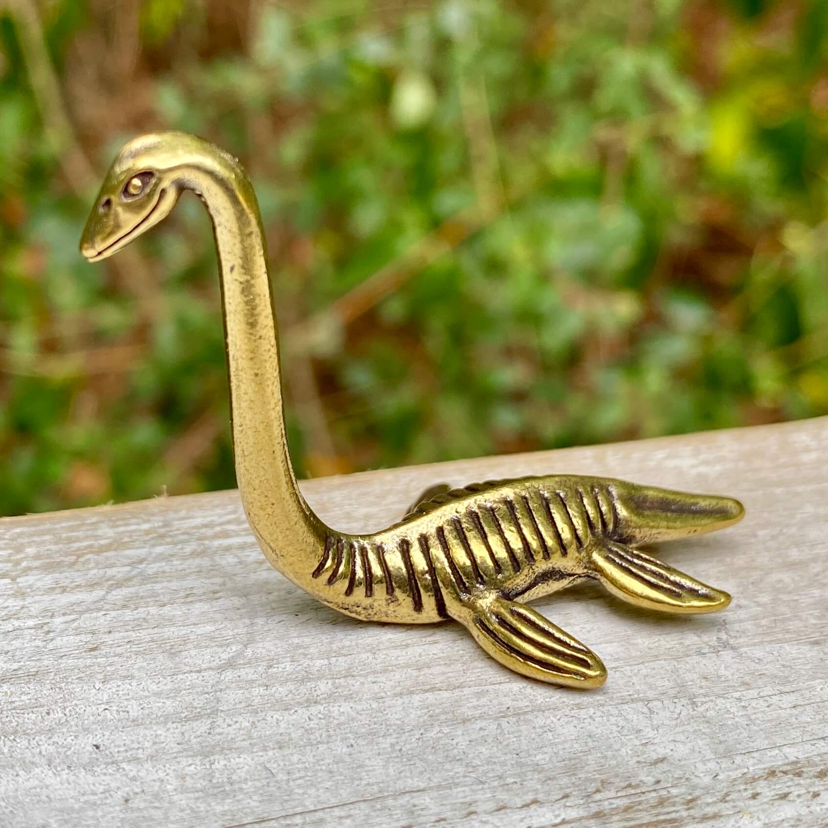 Solid brass Loch Ness Monster figurine by Wild Brass, symbol of mystery and magic, featuring detailed mythical creature design.
