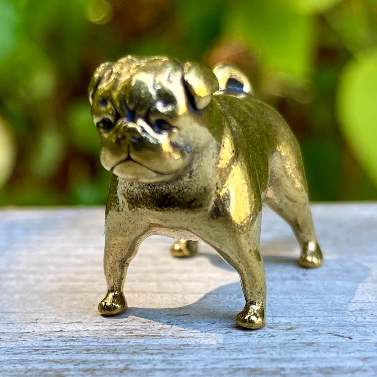 Solid brass pug figurine by Wild Brass, symbol of devotion, charm, and good fortune, featuring a detailed pug dog design.