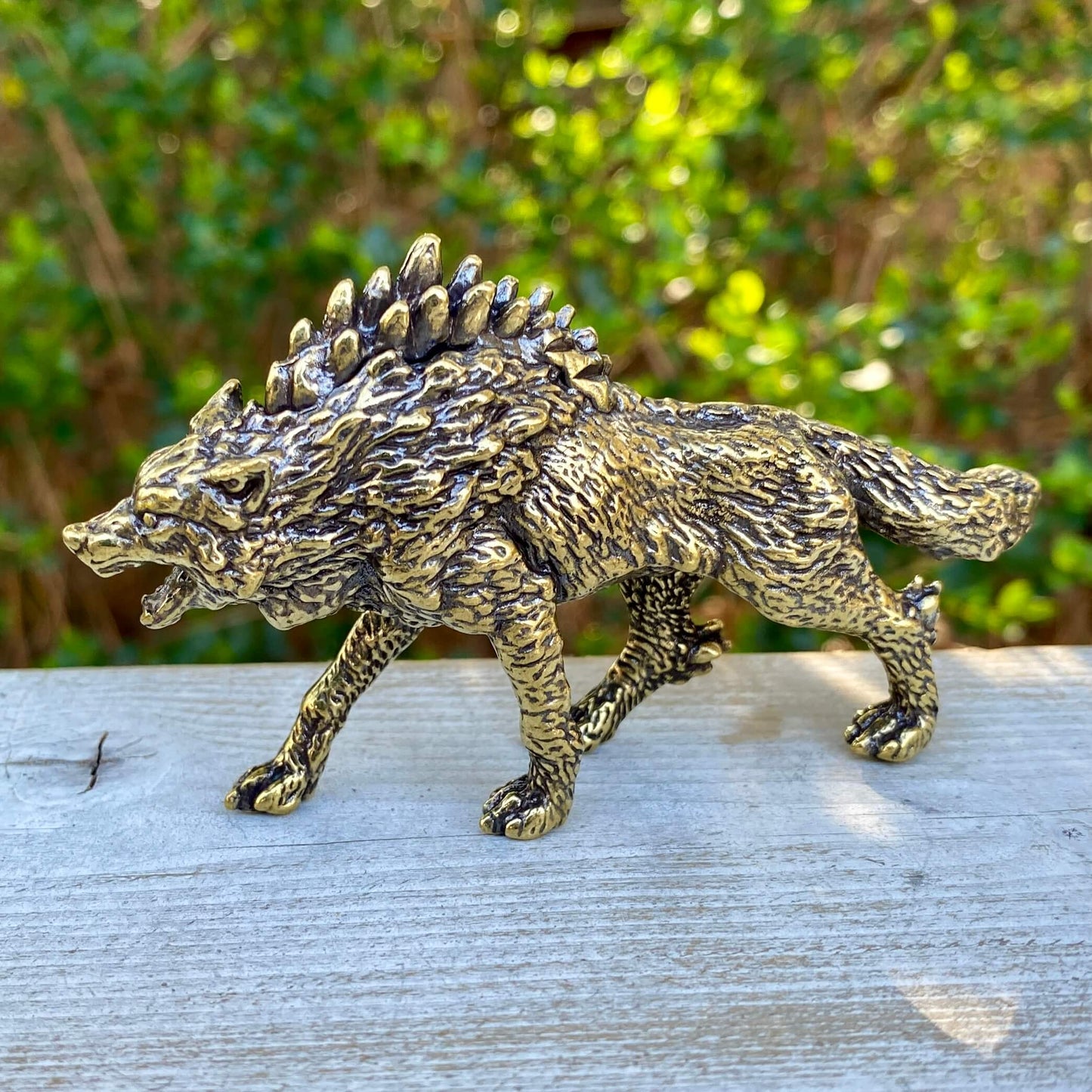 Solid brass Wolverine figurine by Wild Brass, symbol of independence, survival, and untamed spirit, detailed and polished.