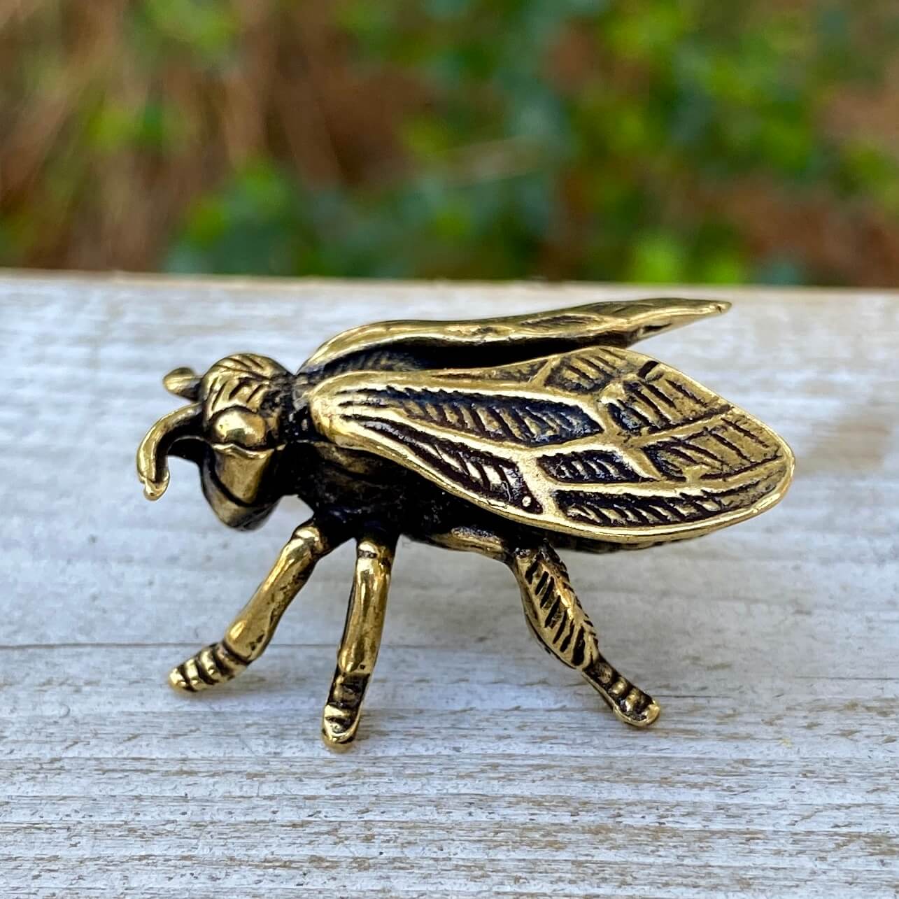 Solid brass wasp sculpture by Wild Brass symbolizing focus, precision, and discipline, with detailed wasp design on a neutral background.