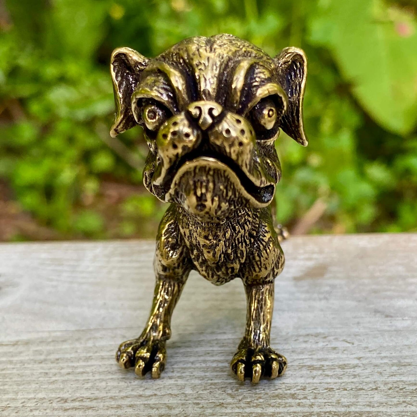 Solid brass Ugly Pug dog figurine by Wild Brass, symbolizing devotion, playfulness, and good fortune, shown in a detailed side view.
