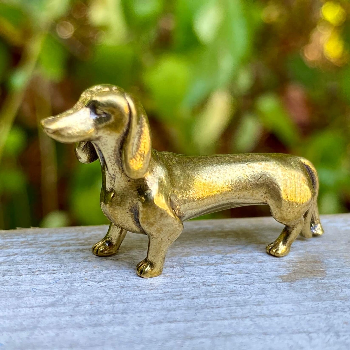 Solid brass dachshund dog figurine by Wild Brass, symbol of courage, loyalty, and tenacity, with detailed craftsmanship.