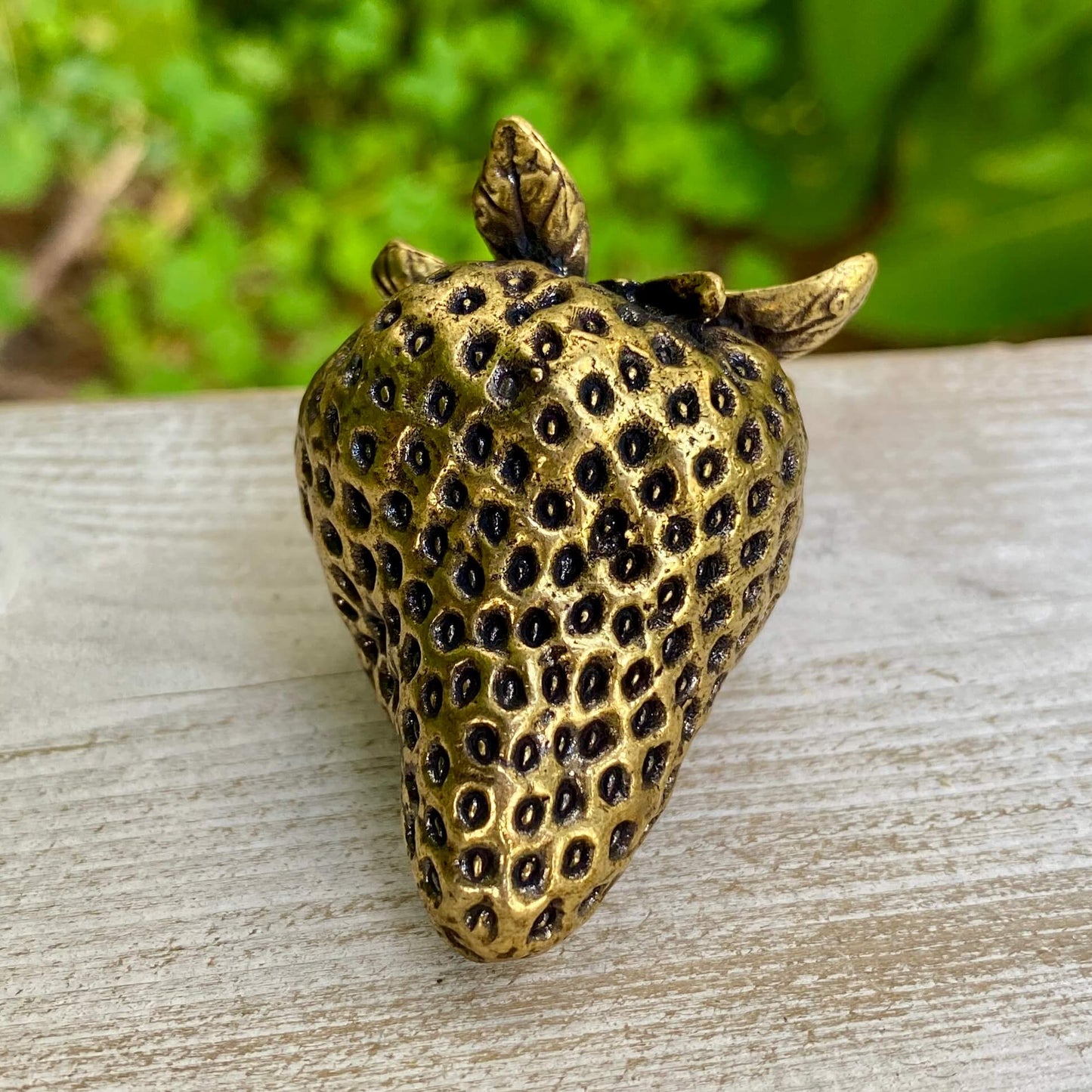 Solid brass strawberry sculpture by Wild Brass, symbol of love, passion, and abundance, with detailed textured surface.